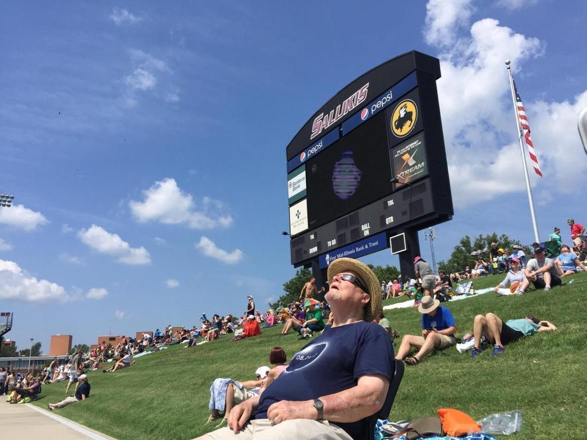 Bob Farris of Palatine gazes at the solar eclipse just minutes after it started to become visible at Saluki Stadium in Carbondale.