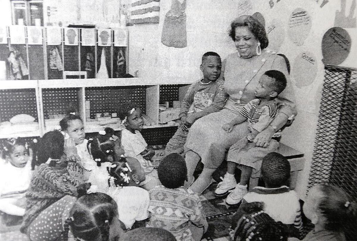 Johnetta Haley, director of SIUE’s East St. Louis Center, is shown with children in the Head Start program she founded in the 1980s.