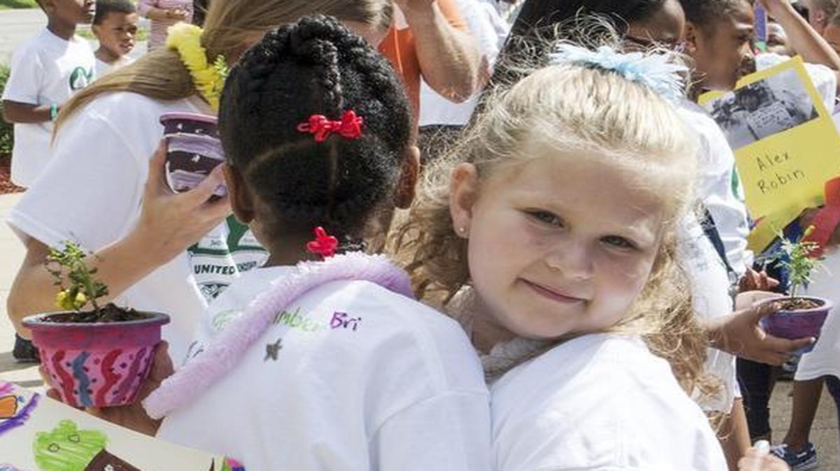 
Ferguson-Florissant 4th grade student Elyssa Gipson hugs her pen pal Jefferson elementary school 1st grade student Teagan Brannaman.
