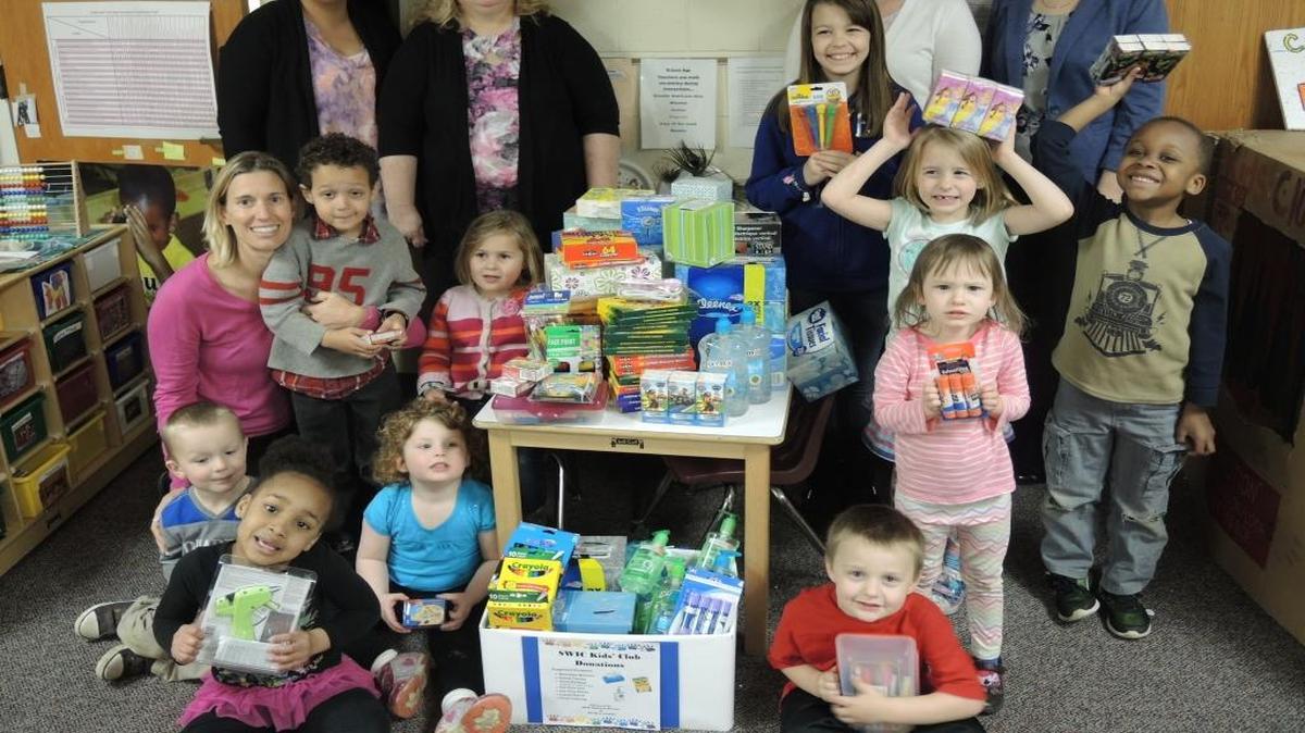 The Southwestern Illinois College Phi Beta Lambda Abe Small Chapter teamed up with the Business Division to collect items for the SWIC Kids’ Club. As part of the community service project, the group collected art supplies, hand sanitizer and facial tissue. Pictured with the Kids’ Club children are SWIC students and PBL members, back row, from left, Christine Ramirez of Swansea, Marilyn Lewallen of Belleville, PBL President Amanda Brown and Vice President Debbie Harris, both of Mascoutah; and Kids’ Club Director Suzette Hechst, second row, left.