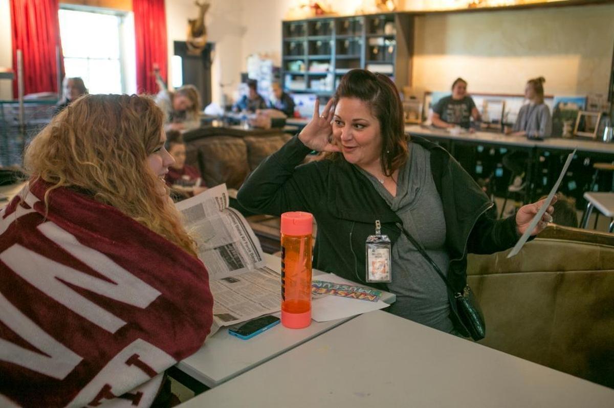 Belleville West High School senior Cailyn Wylie and art teacher Cari Casper-Bassler discuss an art project.