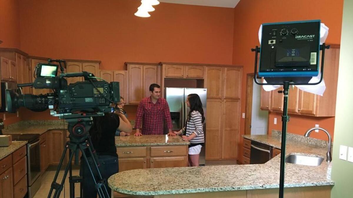 Belleville teacher Hannah Allison talks to her husband Zach as they look through houses in Edwardsville for the HGTV show “House Hunters.”