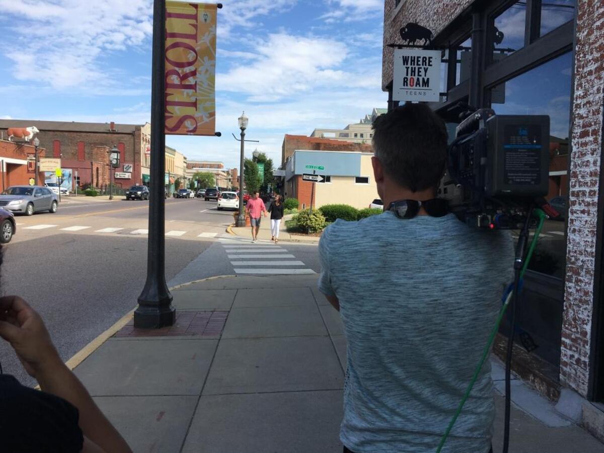 Belleville teacher Hannah Allison and her husband Zach walk down Main Street in downtown Edwardsville during the filming of “House Hunters.” The Allison’s episode aired Monday, Jan. 15, on HGTV.