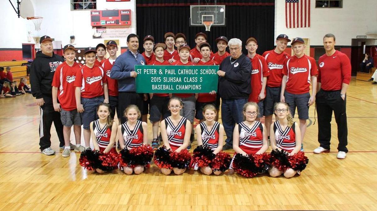 State Rep. Jerry Costello II (holding sign on the left) was joined by Waterloo Mayor Tom Smith (holding sign) on March 10 to present the Saints Peter and Paul Catholic School baseball team with a road sign commemorating the team’s championship win.
