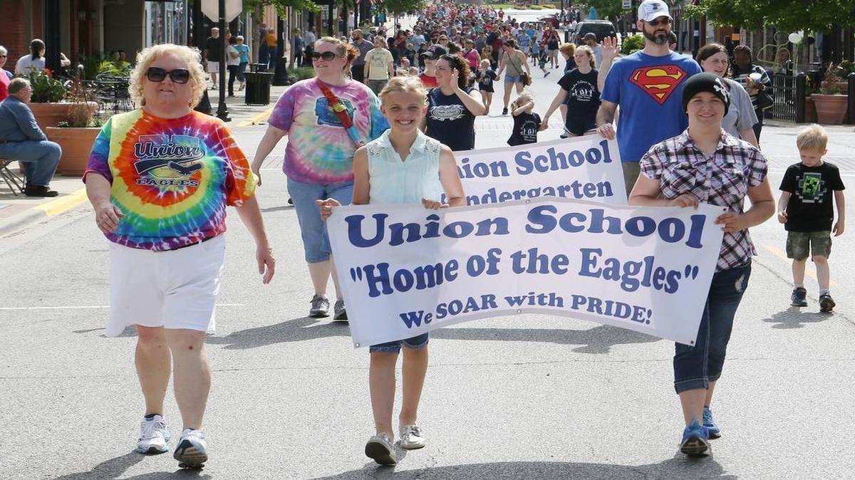
Union Elementary school principal Lori Taylor walks with students Raegen Grawe, and Autumn Kushmaul as they lead Union Elementary School through downtown Belleville. Belleville School district 118 held their annual picnic and parade on Monday.
