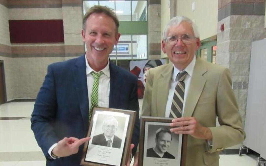Award-winning cartoonist Glenn McCoy and Answer Man Roger Schlueter pose for a photograph at Belleville West High School’s Wall of Fame induction ceremony Sunday.