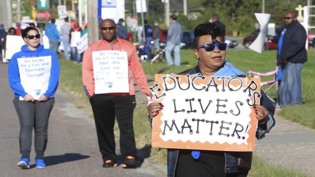 
East St. Louis teachers walk picket in front of the East St. Louis Senior HIgh School last week. At right is is Debra Humphrey-Morgan, coordinator of Career & Technical Education. She has been an educator about 25 years. 
