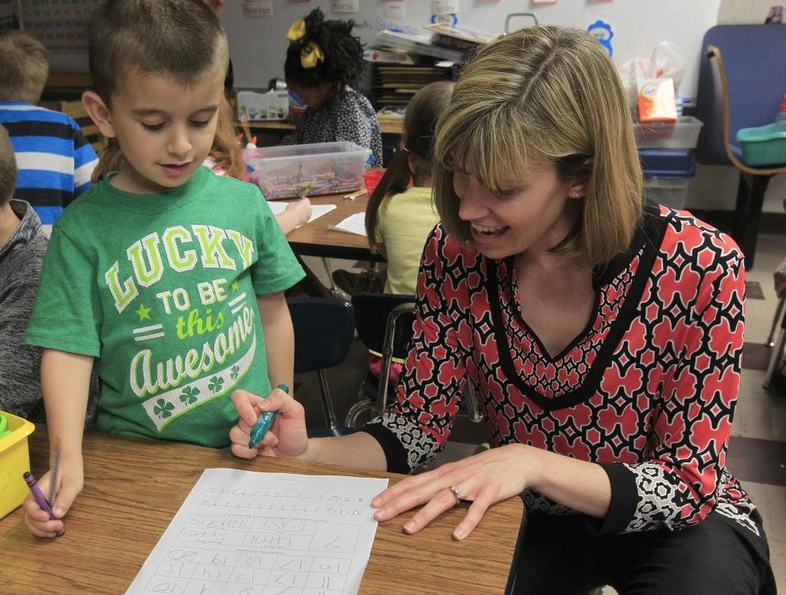 In this 2016 file photo, Renfro Elementary School kindergarten teacher Kelly Stirnaman looks over the math paper of a student during a class session on numbers and counting at the Collinsville school.
