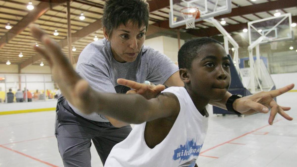 SIUC basketball coach Dana Eikenberger gives Di'Mond Salmond some pointer during the basketball camp at the Family Sportsplex in Belleville.