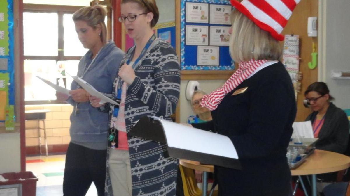 Signal Hill School teachers Katie Jarvis, third grade, Sara Rule, fourth grade, and Liz Murphy, fifth grade, read “The Lorax” to the intermediate students on March 2.