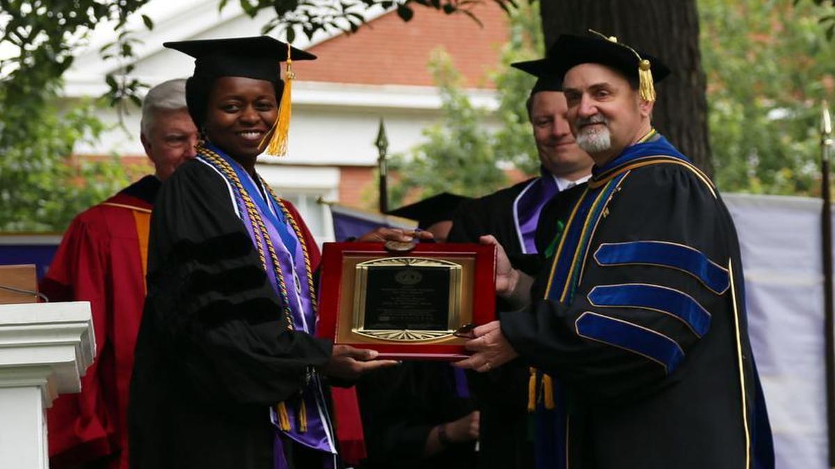 2016 Grandy Faculty Award Winner Dr. John Watters, of McKendree University, receives congratulations from Maria Page, Alumni Association president.