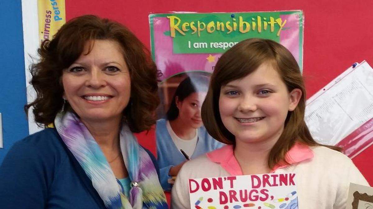 
Isabelle Stark and her teacher, Cindy Collier, at Collinsville Christian Academy. Isabelle is holding the poster that won her second place in the 2015 Alcohol Awareness Poster Contest. 
