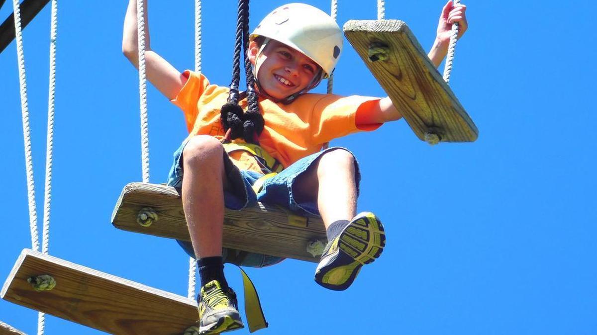 
Saints Peter and Paul Catholic School seventh-grader Paden Schultz climbs in the high ropes course at Camp Wartburg. 
