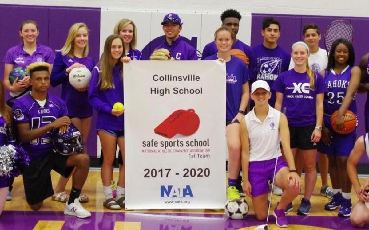 Collinsville High School student athletes pose for a photograph with the school’s banner recognizing it as a Safe Sports School by the National Athletic Trainers’ Association. It will keep the designation for three years.