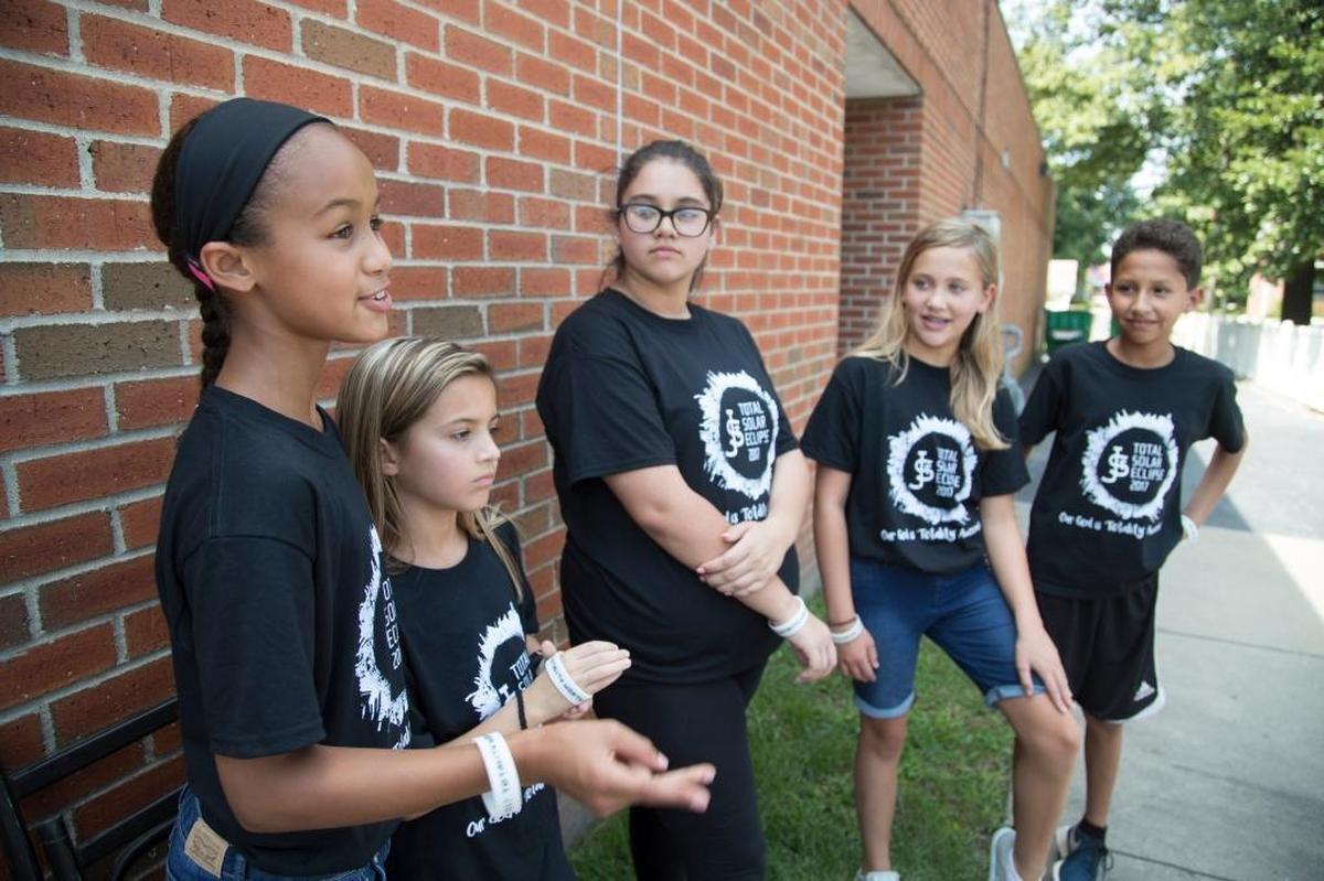 St. James School students Alaina Lester, Charly Bellanca, Evelyn Gonzalez, Tatum Stapf, and Erick Garcia talk about the solar eclipse on Monday afternoon.