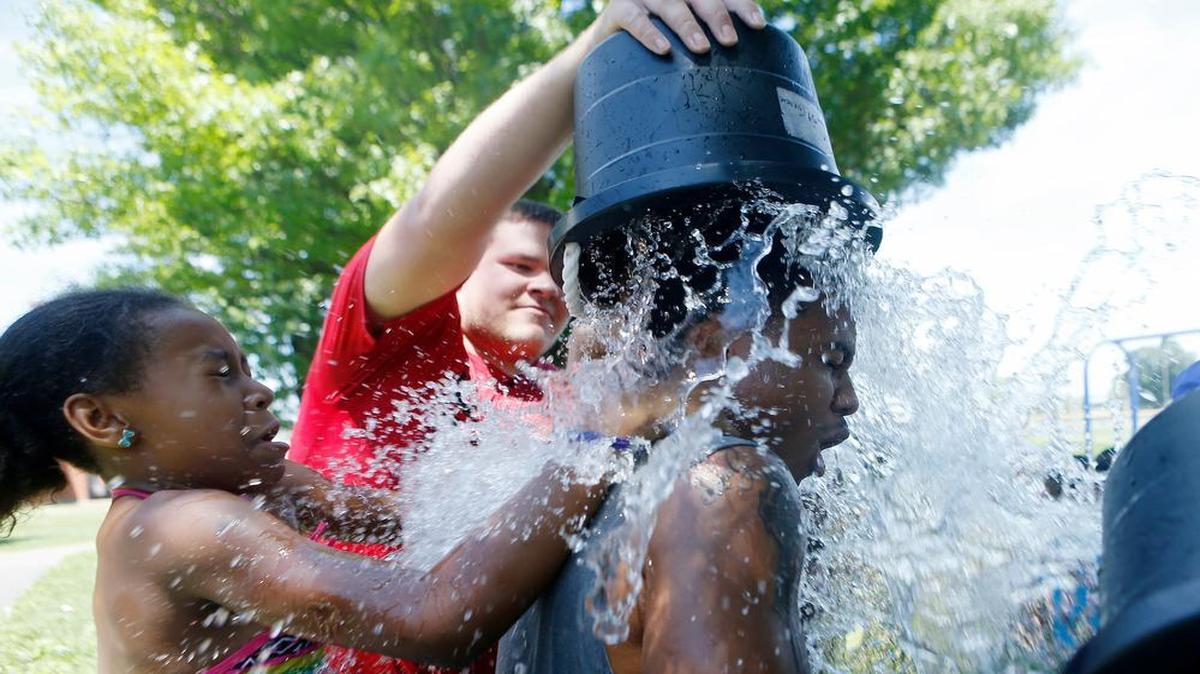 
AmeriCorps counselor Torrence Brwon gets dunked by camper Aaliyah Taylor, 10 and fellow counselor Jacob Brown during the summer camp at West Junior High in Belleville on Wednesday afternoon.
