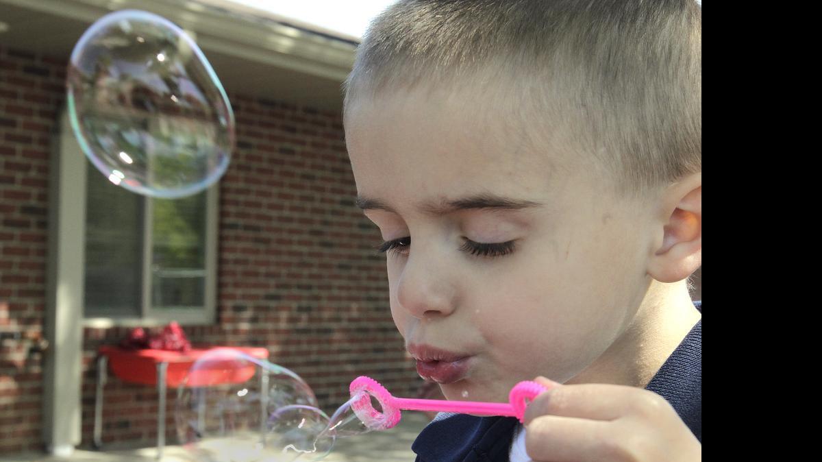 
The Lighthouse Learning Center in Cahokia held a ribbon cutting and open house for education officials, including Beth Purvis, the Illinois Secretary of Education. The center was funded in part by a $1.3 million Early Childhood Construction Grant. Here, Jonathan Knaup, 4 from Cahokia, blows bubbles during outdoor recess time. 
