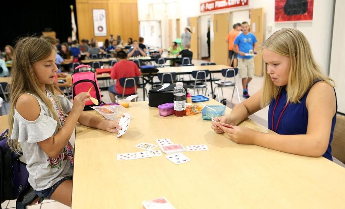 Highland Middle School 7th grade students Maddison Dortch and Mazzy Robertson play a game of Kings in the Corner during lunch.