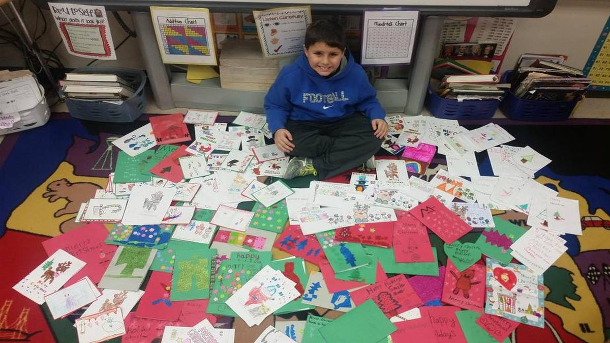 Caseyville Elementary School second-grader Jimmy Fowler sits among the cards he and his peers are making to deliver to children at St. Louis Children’s Hospital.