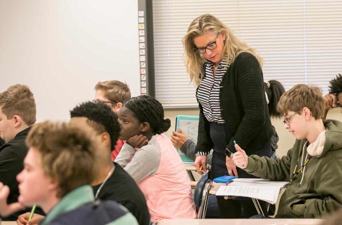 Substitute teacher Kim Atkins checks with students in an eighth-grade math class at Carriel Junior High School in O’Fallon to see if they need any help.