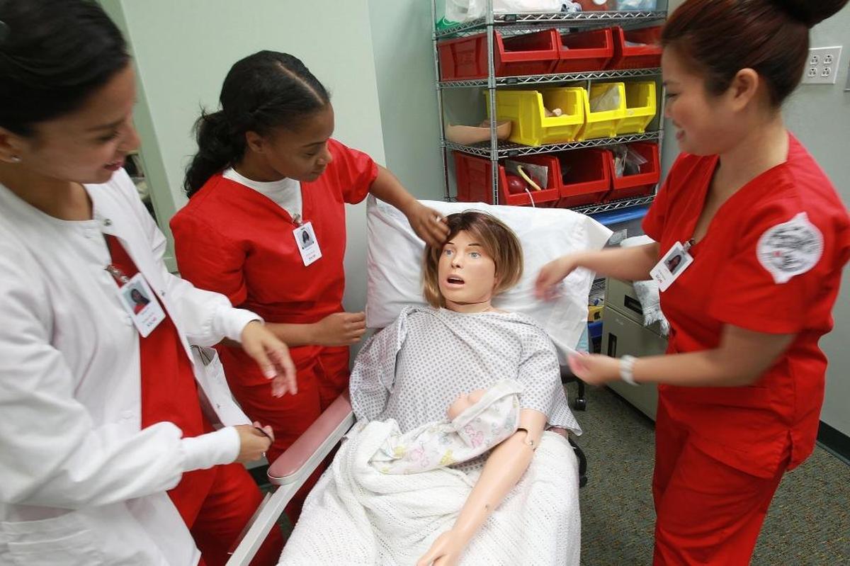 Southern Illinois University Edwardsville nursing students study with a simulator in the Simulate Learning Center for Health Sciences at the SIUE School of Nursing.