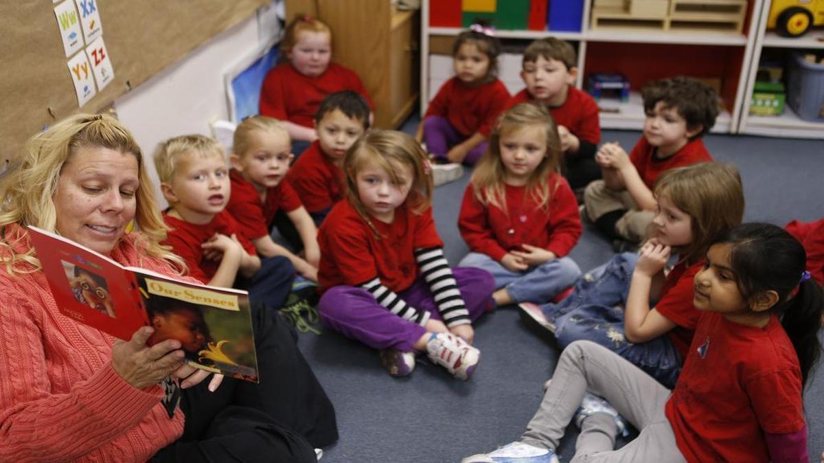 Pre-K teacher Ann Jarrett Mangiaracino reads a book to students at the Granite City Early Childhood Center.