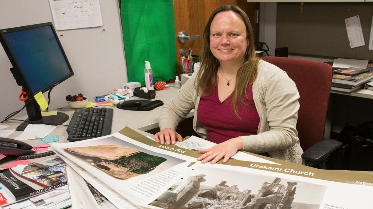 Lindenwood University-Belleville professor Jennifer Welsh displays some of the materials that will be part of a presentation on the 70th anniversary of the bombing of Hiroshima and Nagasaki.