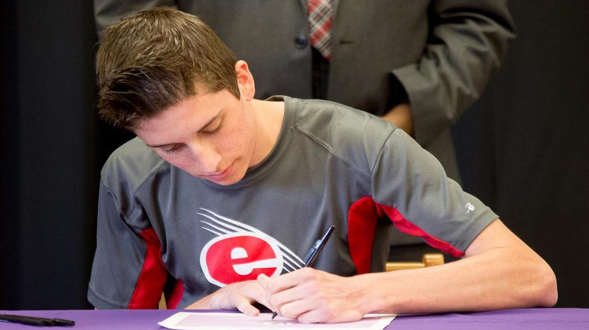 Colllinsville senior Dustin Hartlein signs a letter of intent on Monday at Collinsville High School’s Academic Signing Day.
