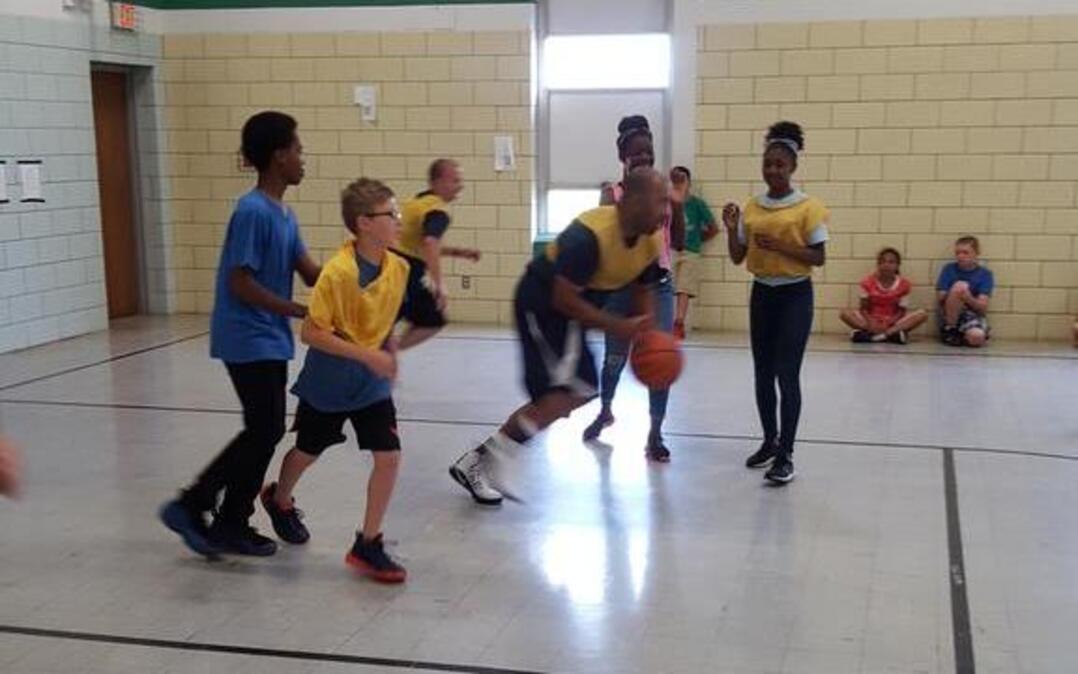Douglas Elementary School sixth graders play a game of basketball with some Belleville firefighters and their superintendent, Matt Klosterman, on May 17, 2017, to celebrate the end of the school year.