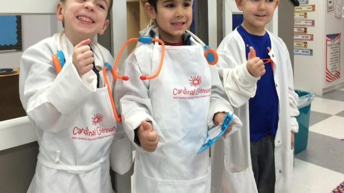 Nathan Epperheimer, Jack Schuette, and Liam Compton of St. John Neumann Catholic School use hospital-donated items in the dramatic play center.