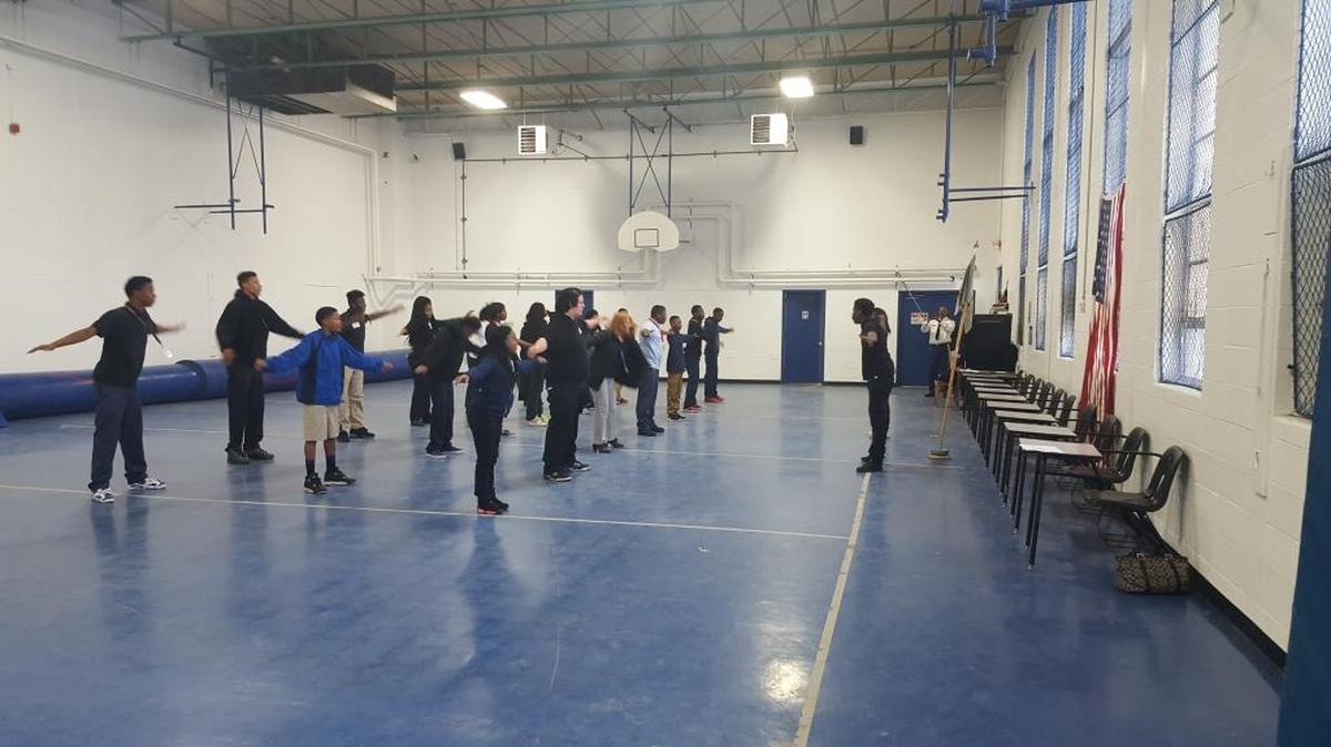 Cadet Tremaine Watson leads fellow cadets and teachers in a physical training session using Army standards at the JROTC open house in early February.