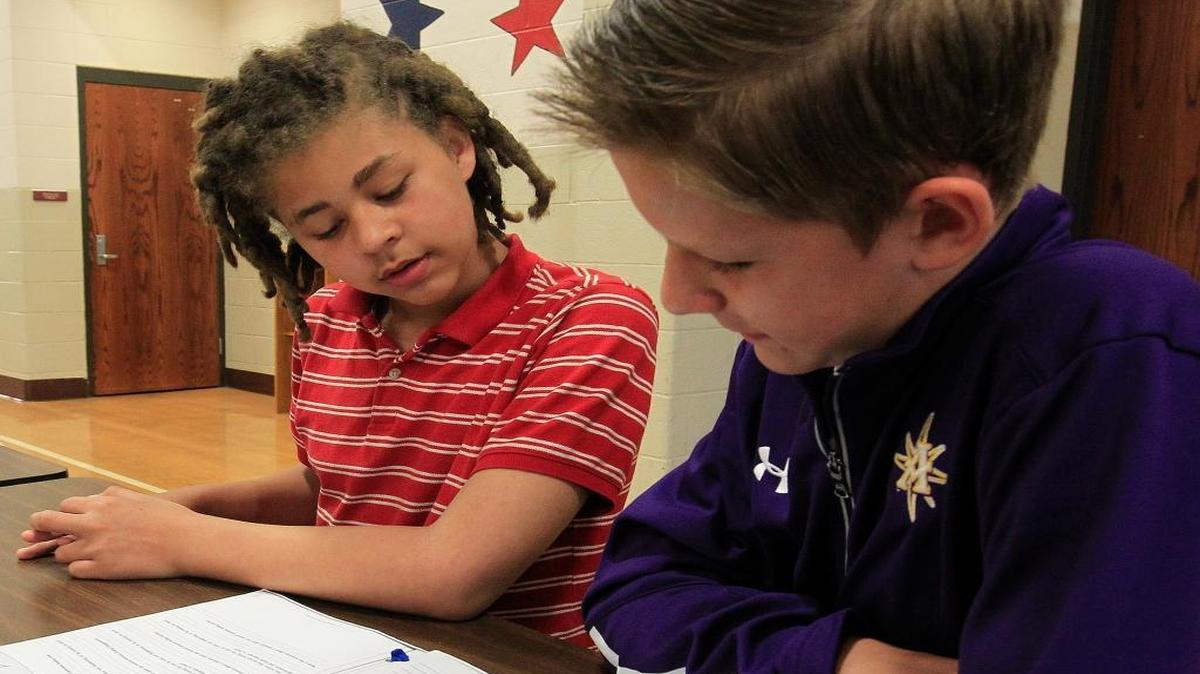 James Moton, a sixth grade student (left), listens to his mentor William Hein, also a sixth grader, as William gives examples of inappropriate and appropriate behavior and reactions in certain social occasions. Both are Westhaven Elementary School sStudents.