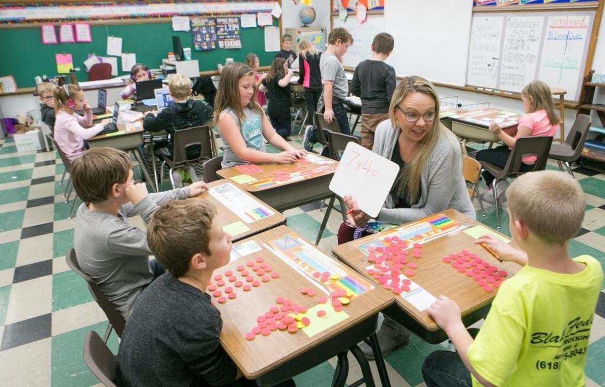 New Athens Elementary school third grade math teacher Sarah Duensing works with students on multiplication. Over three years of PARCC testing, New Athens Elementary is one of the most improved schools.