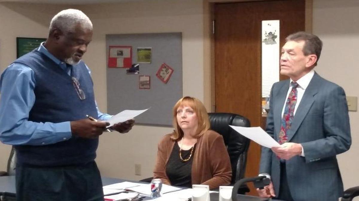 Dr. Nathaniel Anderson, a new member on the Harmony School District 175 school board, recites his oath of office during Monday evening’s meeting. Anderson replaces Bob Peyman, who resigned after moving out of the district.