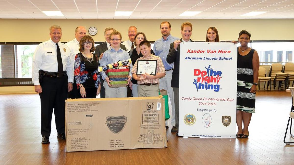 
At the Do The Right Thing kickoff breakfast on Friday morning, Belleville student Xander Van Horn was awarded the Candy Green Student of the Year. From left are Chief Sam Dotson, of the St. Louis Metro Police Department, Chief Nick Gailius, of the Fairview Heights Police Department, Candy Green, Superintendent Matt Klosterman, Xander Van Horn, Chief Jon Belmar, of the St. Louis County Police Department, Xander’s brother, Quinn and his parents Joe and Beth, and Principal Ed Langen, of Abraham Lincoln Elementary and unidentified staff members. 
