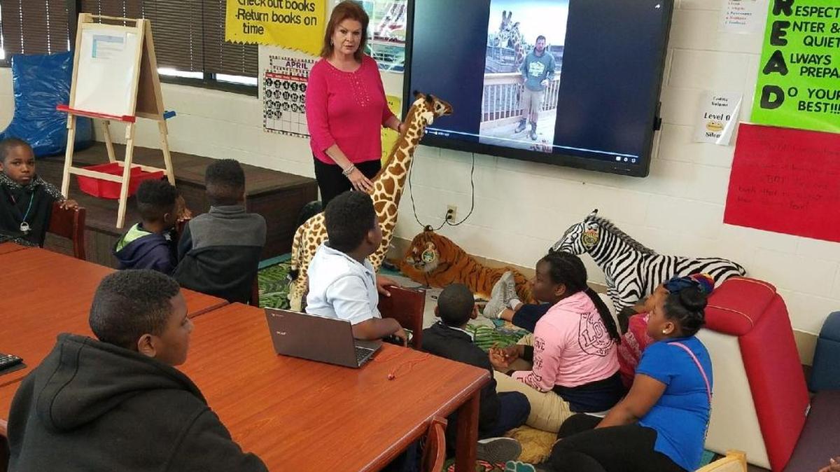 Librarian Donna Cameron discusses the pregnancy of a giraffe named April with students at Gordon Bush Elementary in East St. Louis. Animal Adventure Park, a privately-owned New York zoo, started livestreaming from April’s enclosure in February. When April finally gave birth on April 15, at least 1.2 million viewers were watching online.