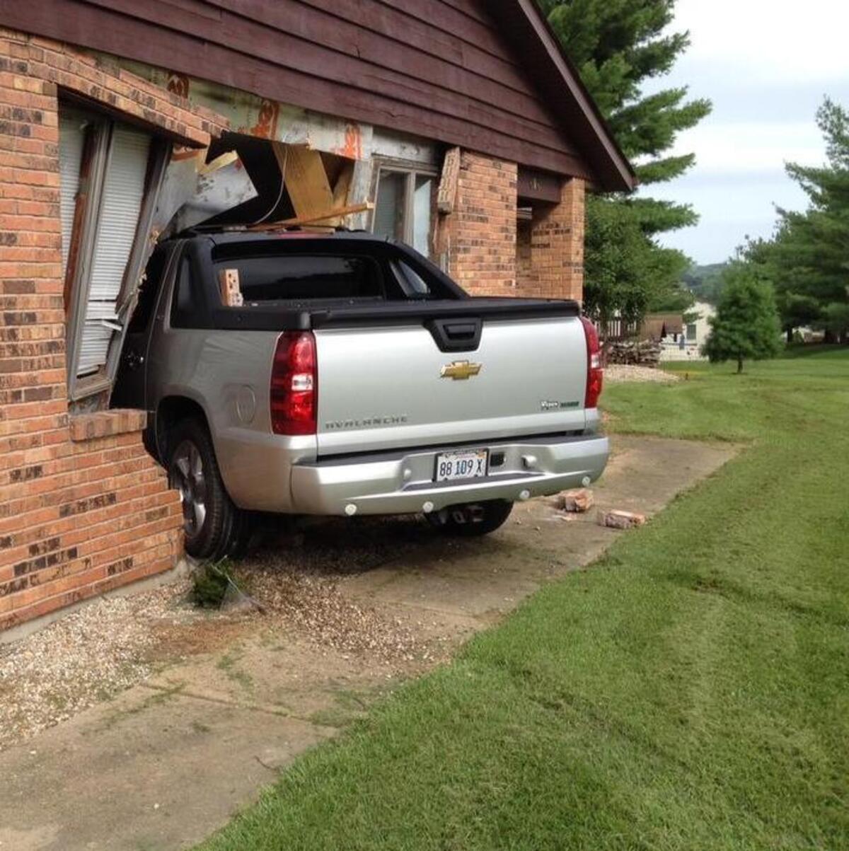 
A silver Chevy Avalanche rests in the hole it smashed through the garage of a home on West Park Drive in Columbia on Thursday afternoon. The residents were not inside when the crash occurred.
