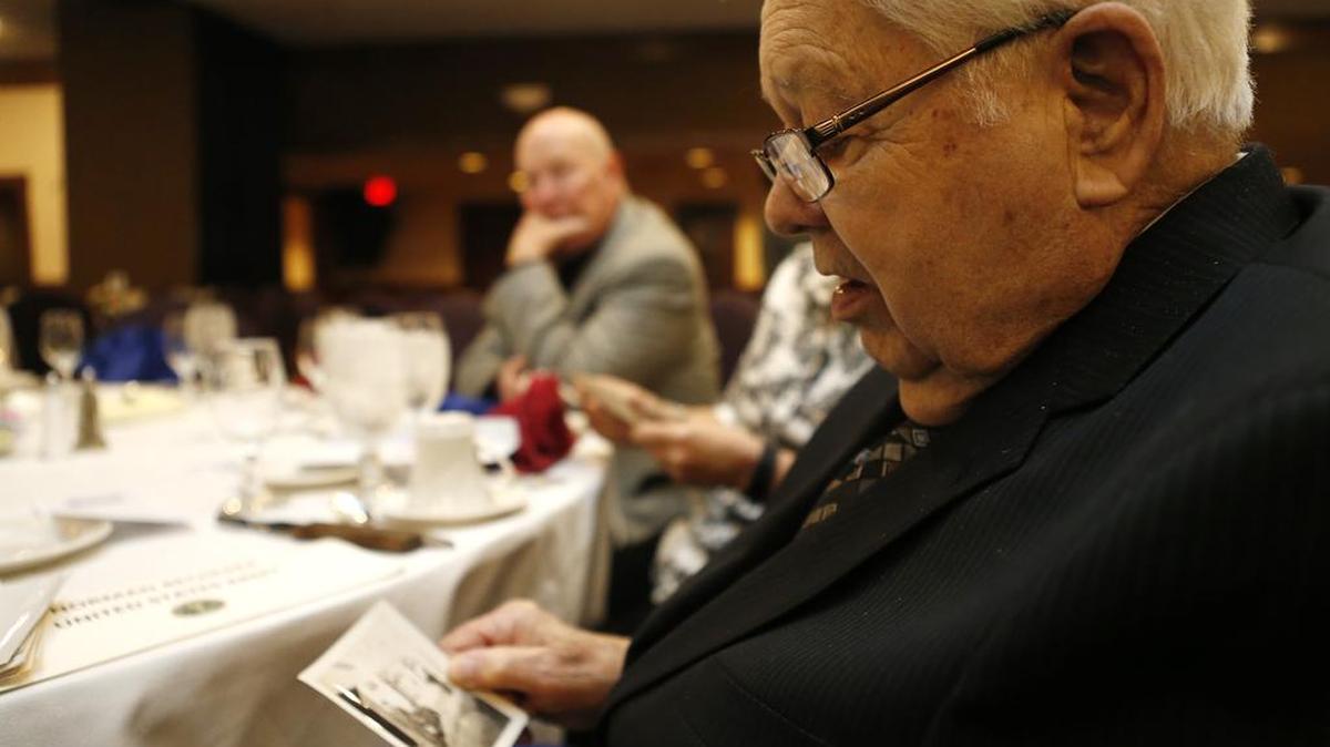 World War II veteran Norman Becherer of Belleville shows a photograph of himself that was taken during World War II. Becherer was one of the veterans honored during the 66th annual Belle-Scott Dinner at Fischer's in Belleville on Thursday evening.