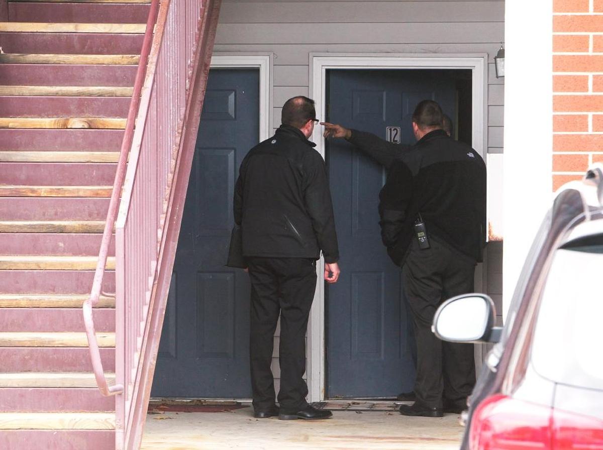 Fairview Heights Detective Todd Huskey (left) and O’Fallon Detective Brian Gimpel speak to an apartment occupant at the Longacre Ponds Apartments where a man was shot in the head Tuesday evening. Police were going door-to-door in the apartment complex looking for potential witnesses. A 15-year-old was charged as an adult in his death.