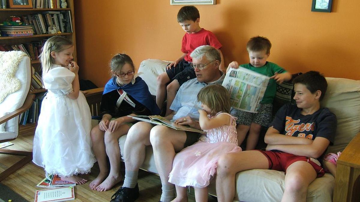 
Sen. Bill Haine reads to some of his grandchildren in 2012.
