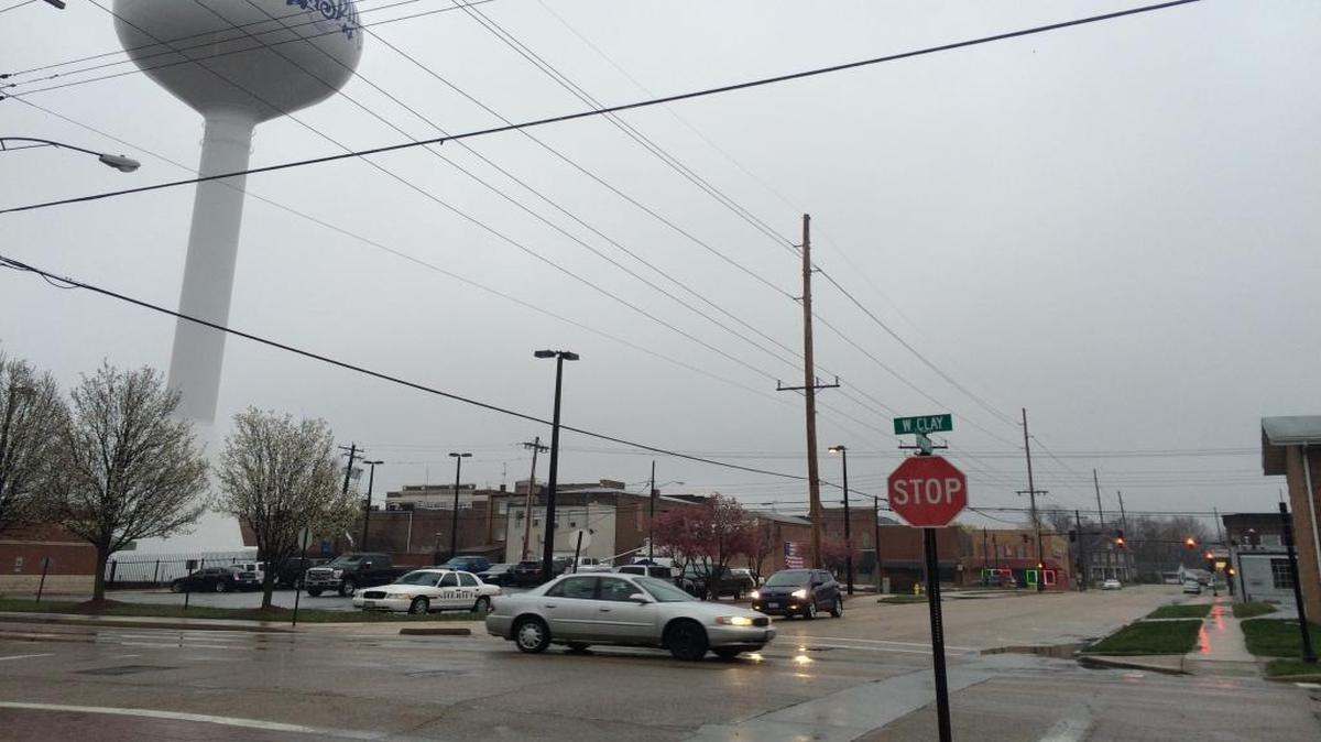 Cars drive through scattered rain and snow Sunday morning near downtown Collinsville.