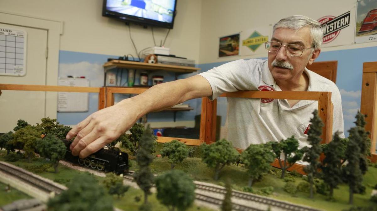 Metro East Model Railroad Club Vice President Bob Gibson makes adjustments on an HO Scale railroad in preparation for an open house on New Year’s Eve at the old Glen Carbon Firehouse and Village Hall.