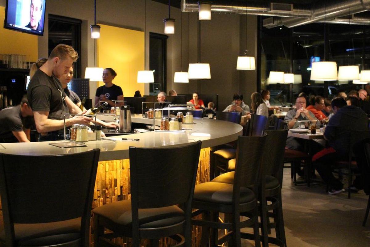 The new Dewey’s Pizza restaurant in O’Fallon has high ceilings, exposed ductwork, pendulum lights and a modern half-circle bar in its main dining room, which seats about 100 people.