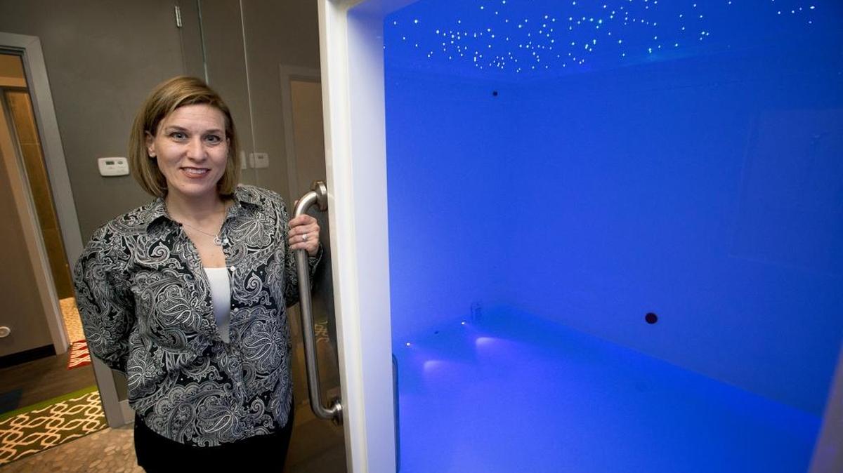 Cheri Koene, co-owner of Float Center Shiloh, shows off the king-sized float room. Each float chamber is maintained at near body temperature: 95.5 degrees and has a variety of lighting and sound choices.