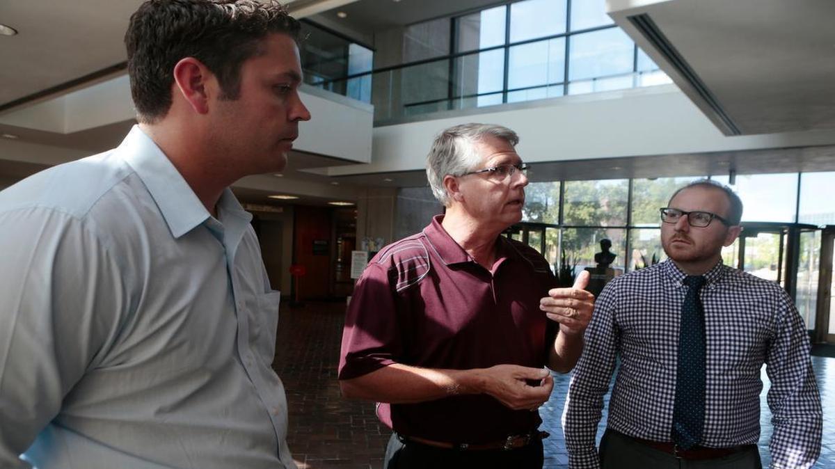 
From left: Attorneys John Hipskind, and far right, Brady McAninch of Hipskind & McAninch, LLC., and St. Clair Township Highway Commissioner, John “Skip” Kernan (center) talk to a reporter about the lawsuit related to the controversial sewer services contract between St. Clair Township and Swansea.
