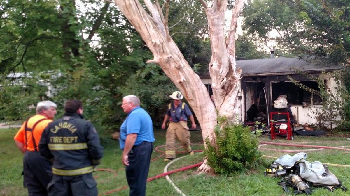 
Firefighters gather in front of a home in the 1000 block of St. Margaret Drive in Cahokia Wednesday evening shortly after the fire that destroyed it was extinguished.
