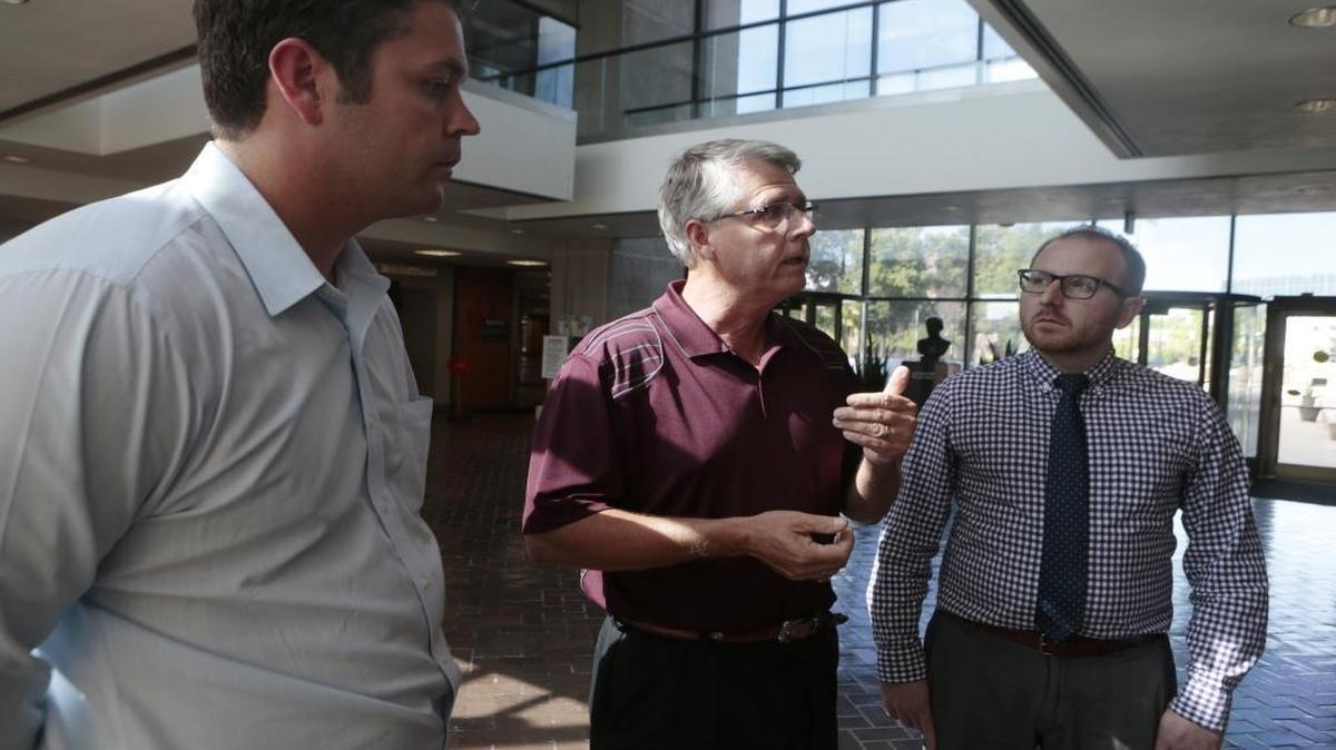 From left: Attorneys John Hipskind, and far right, Brady McAnich of Hipskind & McAnich, LLC., and St. Clair Township Highway Commissioner Skip Kernan (center) talk to a reporter in June 2015 about a township issue with a sewer services contract. Kernan recently laid off five employees in the St. Clair Township Highway department. The layoffs took place after a budgetary dispute between Kernan and township trustees.