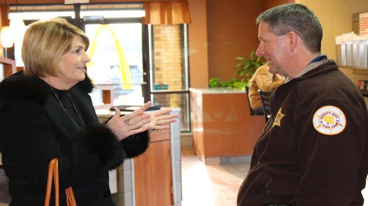 Signal Hill School District Superintendent Suzette Lambert talks to a St. Clair County Sheriff’s Department deputy during a Coffee with a Cop event on Wednesday in Belleville.