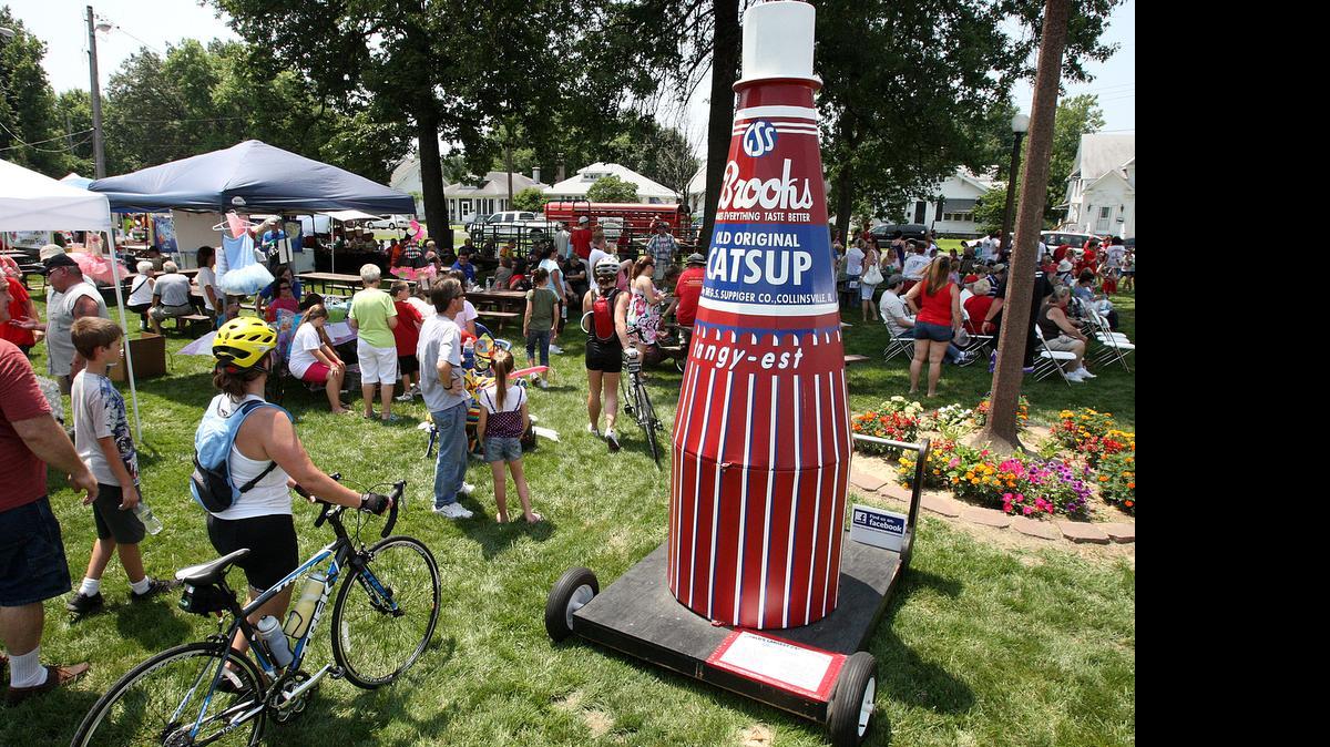 
Attendees file past a model of the Brooks Catsup bottle at the 2011 World’s Largest Catsup Bottle Festival in Collinsville.
