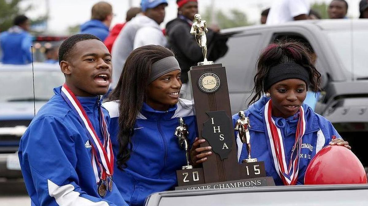 
Cahokia High School track athletes Marquis Murray (from left), Raynesha Lewis and Mariya Hudson get a ride Sunday as part of the celebration of the school's state championship track win. The boys and girls teams, family, friends and other teams from the school drove through town in various vehicles, including atop fire trucks.
